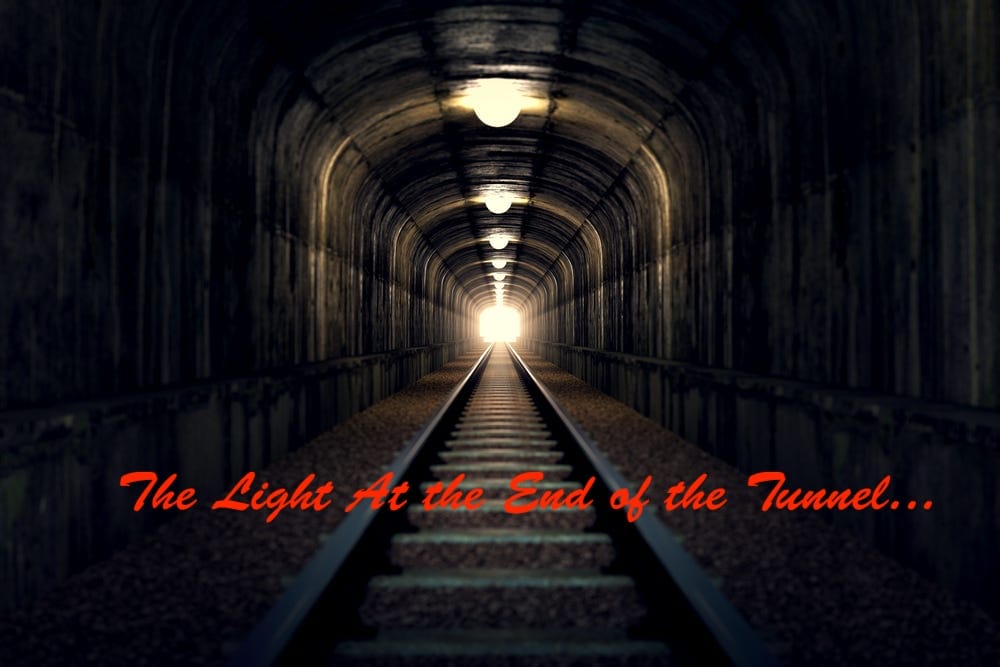 Image showing oncoming train in a tunnel with the words 'The light at the end of the tunnel...' overlayed