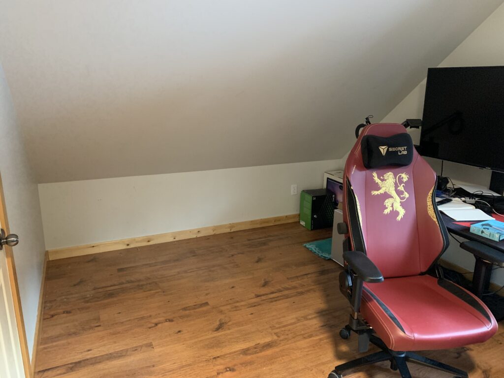 corner of room with angled roof illustrating space cleared by unpacking boxes